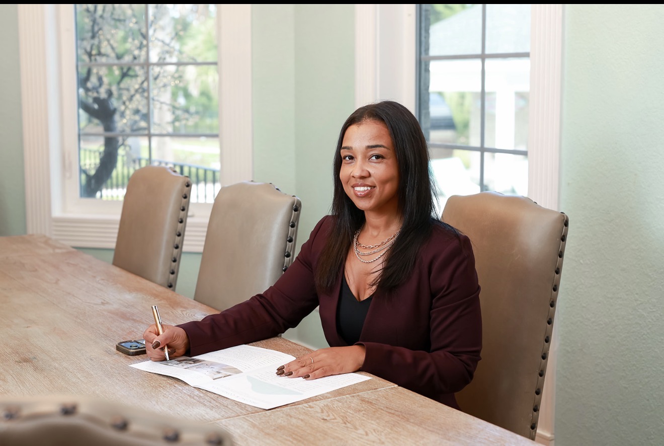 Bianca Edge reviewing real estate documents at a table