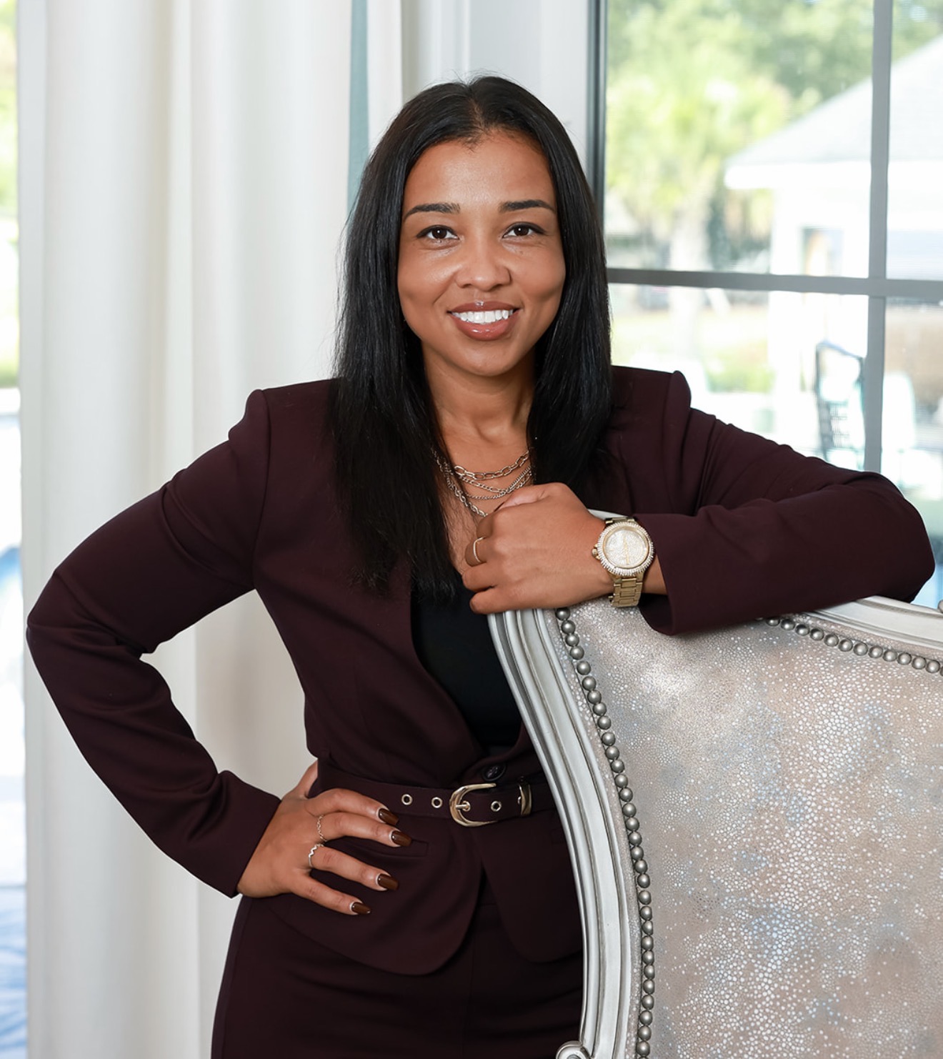 Bianca Edge smiling in a burgundy suit
